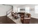 Comfortable living room with leather furniture and a staircase in the background at 249 Wendover Pkwy, Pittsboro, NC 27312