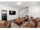 Inviting living room with hardwood floors, leather seating, and neutral-colored walls at 249 Wendover Pkwy, Pittsboro, NC 27312