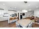 Open-concept living area featuring a modern kitchen with a large island, dining area, and comfortable seating at 249 Wendover Pkwy, Pittsboro, NC 27312
