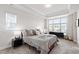 Inviting main bedroom featuring a tray ceiling and an abundance of natural light at 249 Wendover Pkwy, Pittsboro, NC 27312