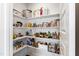 Walk-in pantry featuring bright lighting and shelving full of food and cooking supplies at 249 Wendover Pkwy, Pittsboro, NC 27312