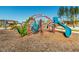The community playground features a colorful dinosaur themed climbing structure at 249 Wendover Pkwy, Pittsboro, NC 27312