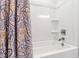 Clean and modern shower with white tile and a patterned shower curtain at 249 Wendover Pkwy, Pittsboro, NC 27312