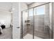 The large glass shower includes tiled walls, a window, and built-in shelving in the main bath at 249 Wendover Pkwy, Pittsboro, NC 27312