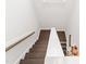 Modern staircase with white risers, wooden treads, and a sleek white handrail at 249 Wendover Pkwy, Pittsboro, NC 27312