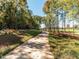 A paved walking trail meanders through a scenic, tree-lined community, ideal for walking, jogging, and enjoying nature at 249 Wendover Pkwy, Pittsboro, NC 27312