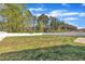 Large, enclosed backyard featuring a stone patio and verdant trees; a private outdoor oasis at 274 Ashpole Trl, Clayton, NC 27520