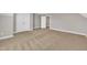 Open bonus room with neutral paint, carpet, natural light, and open floor plan at 274 Ashpole Trl, Clayton, NC 27520