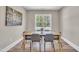 Bright dining room features a wood table, gray chairs and natural light from the outdoor view at 274 Ashpole Trl, Clayton, NC 27520