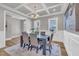 Dining room boasts coffered ceilings, neutral walls, and wood floors with seating for six at 274 Ashpole Trl, Clayton, NC 27520