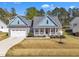 Attractive home with a two-car garage, covered porch, and well-kept lawn at 274 Ashpole Trl, Clayton, NC 27520