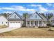 Charming two-story home with inviting front porch, two-car garage, and manicured lawn at 274 Ashpole Trl, Clayton, NC 27520