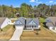 Aerial view of a beautifully constructed house with a spacious driveway, two-car garage and landscaped yard at 274 Ashpole Trl, Clayton, NC 27520