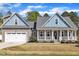 Charming home with two-car garage, covered porch, and manicured lawn at 274 Ashpole Trl, Clayton, NC 27520