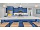 Stylish kitchen island features white countertop, blue cabinetry, and seating for four at 274 Ashpole Trl, Clayton, NC 27520
