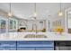 Kitchen island featuring white countertops and sink, offering an open view to the living area at 274 Ashpole Trl, Clayton, NC 27520