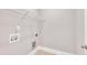 Functional laundry room with white walls, utility connections, and upper shelving at 274 Ashpole Trl, Clayton, NC 27520