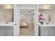 Bright main bathroom has double vanities and mirrors with an open view to the bedroom at 274 Ashpole Trl, Clayton, NC 27520