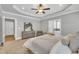 Comfortable main bedroom features a ceiling fan, tray ceiling, and an en-suite bathroom at 274 Ashpole Trl, Clayton, NC 27520