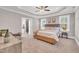 Spacious main bedroom features a ceiling fan, tray ceiling, and windows offering plenty of light at 274 Ashpole Trl, Clayton, NC 27520