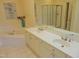 Elegant bathroom featuring double sinks, a soaking tub, and a separate glass-enclosed shower at 2801 Glenwood Gardens Ln # 106, Raleigh, NC 27608