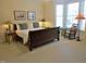 Cozy bedroom with a sleigh bed, bay window, rocking chair and soft, neutral carpeting for a relaxing space at 2801 Glenwood Gardens Ln # 106, Raleigh, NC 27608