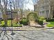 Community garden area with manicured shrubbery and stone archways surrounded by tall trees at 2801 Glenwood Gardens Ln # 106, Raleigh, NC 27608
