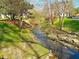 Scenic creek view with lush green banks and trees, creating a serene natural environment near the property at 2801 Glenwood Gardens Ln # 106, Raleigh, NC 27608