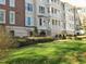 Elegant multi-story building with brick accents, multiple balconies, and well-manicured lawn at 2801 Glenwood Gardens Ln # 106, Raleigh, NC 27608