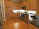 Well-equipped kitchen with stainless steel appliances, light wood cabinetry, and hardwood flooring at 2801 Glenwood Gardens Ln # 106, Raleigh, NC 27608