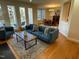 Open concept living room leading to dining area with balcony access and hardwood floors at 2801 Glenwood Gardens Ln # 106, Raleigh, NC 27608