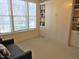 Versatile room featuring a pull-down Murphy bed, built-in bookshelves, and natural light at 2801 Glenwood Gardens Ln # 106, Raleigh, NC 27608
