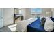 Bright bedroom featuring a window, dresser with mirror and a blue and white color scheme at 296 Providence Creek Dr, Fuquay Varina, NC 27526