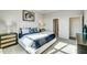 Inviting bedroom featuring a large bed, soft lighting, and access to the ensuite bathroom at 296 Providence Creek Dr, Fuquay Varina, NC 27526