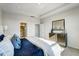 Comfortable bedroom with ensuite bath access, dresser with mirror and a blue and white color scheme at 296 Providence Creek Dr, Fuquay Varina, NC 27526