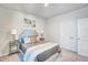 Cozy bedroom features a tufted headboard, neutral color palette, and carpet at 296 Providence Creek Dr, Fuquay Varina, NC 27526