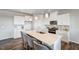 Modern kitchen with an island, white cabinets, and stainless steel appliances at 296 Providence Creek Dr, Fuquay Varina, NC 27526