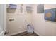 Functional laundry room with shelving, modern art and luxury vinyl flooring at 296 Providence Creek Dr, Fuquay Varina, NC 27526