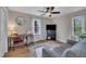 Comfortable bedroom features a ceiling fan, a window, and a cozy sitting area at 3022 Dixon Rd, Durham, NC 27707