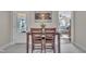 Dining area with view to a sunroom on one side, and an opening to the living room on the other at 3022 Dixon Rd, Durham, NC 27707