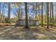 View of the side and back of the house with mature trees surrounding the property at 3022 Dixon Rd, Durham, NC 27707