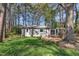 Charming home with a small porch surrounded by lush greenery and mature trees offering a private, serene setting at 3022 Dixon Rd, Durham, NC 27707