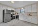 Charming kitchen with stainless steel appliances, white cabinetry, and tiled floors at 3022 Dixon Rd, Durham, NC 27707