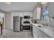 Well-lit kitchen featuring modern stainless steel appliances and white cabinets for ample storage at 3022 Dixon Rd, Durham, NC 27707