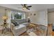 Bright living room features large windows, hardwood floors, ceiling fan, and comfortable seating for relaxing and entertaining at 3022 Dixon Rd, Durham, NC 27707