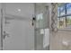 Modern shower stall with glass door, a shower head, and a shower chair at 3022 Dixon Rd, Durham, NC 27707