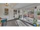 The enclosed porch features a sliding glass door to the wooded area, a door, and a washer and dryer at 3022 Dixon Rd, Durham, NC 27707