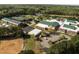 An aerial view showcases a school with a green roof, a baseball field and ample parking at 317 Flatrock Ln, Holly Springs, NC 27540