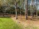 Fenced backyard offers both grassy areas and a wooded area, perfect for privacy and outdoor activities at 317 Flatrock Ln, Holly Springs, NC 27540