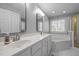 Bathroom showcasing a double sink vanity, garden tub and glass enclosed shower at 317 Flatrock Ln, Holly Springs, NC 27540